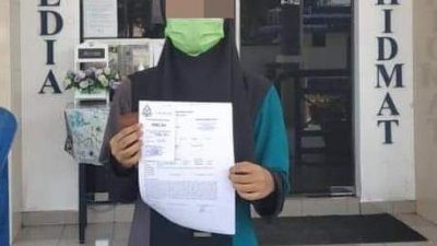 女学院生在哥打士打警局报案后展示报案纸。