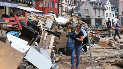 在德国北莱茵-威斯特法伦州的市镇巴特明斯特莱费尔，周一在洪水退去后，灾场损毁惨不忍睹，民众和警察回到家园进行清理和重建工作。（图取自路透社）