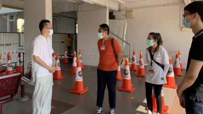 新加坡裕廊集选区议员陈有明(左)周日上午走访临时检测站。