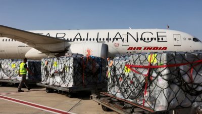在以色列特拉维夫的本古里安国际机场，工人们在周二准备把运送到印度的医疗物资装载上飞机。(图取自路透社)