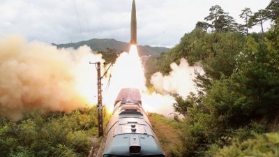 朝鲜官媒上周四发布照片显示，朝鲜铁道机动导弹团于上周三到中部山区接受射击训练，从列车上发射导弹，击中东海800公里水域的目标。（图取自朝中社/法新社）
