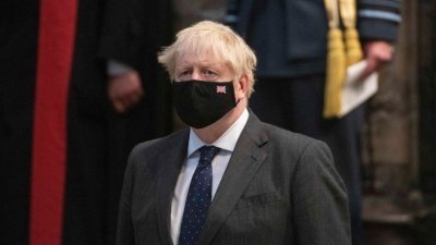 英国首相约翰逊当地时间周日戴著口罩，参加了在伦敦市中心威斯敏斯特教堂举行的纪念不列颠之战81周年的感恩节和再献仪式。（图取自法新社）