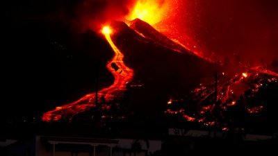 老昆布雷火山入夜后，仍然不断喷发，炽热的熔岩和火山灰喷上数百公尺的半空，部分熔岩沿著山坡流下，形成一条条火红色的河流。（图取自路透社）