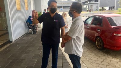 刘志俍（右）向祖尔莱米了解又见马六甲剧场疫苗接种中心的整体运作。