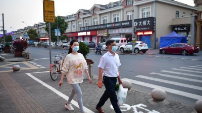 上海市放松了一些地区的封锁，金山区枫泾镇的街道上可见民众出门购买日用品。（图取自路透社/中国新闻图片网）