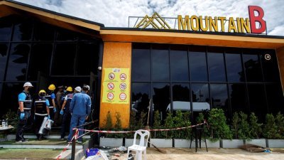 泰国春武里省一家夜店于周五发生大火，造成13人死亡。在火势扑灭后，法医抵达现场处理后续工作。（图取自路透社）