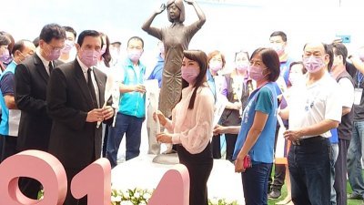 台湾前总统马英九（前左）周日出席在台南市中西区“慰安妇”纪念铜像前举办的国际“慰安妇”纪念日追思会，与参与民众先后献花致意。（图取自中央社）