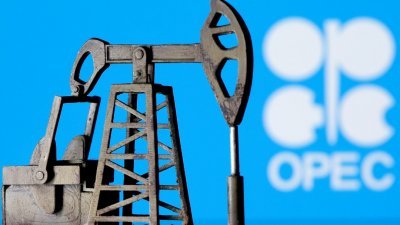 插图显示在OPEC徽标前面，可以看到一个3D打印的油泵千斤顶。（图取自路透社档案照）