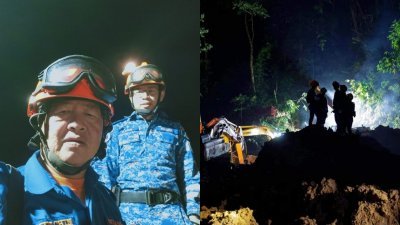 江伟贤(后者）与同伴站在最前线日夜搜寻峇冬加里营地土崩失踪者。