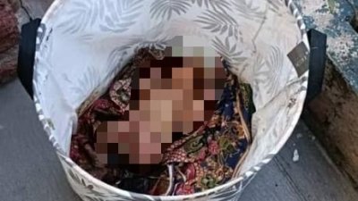 女婴被放在洗衣篮内，以峇迪布包裹著。（照片由警方提供）