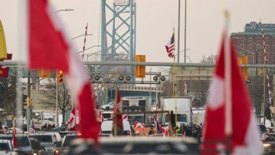 “自由车队”的货车司机和支持者，在安大略省温莎市大使桥过境点的加拿大方向封锁了交通。（图取自法新社）