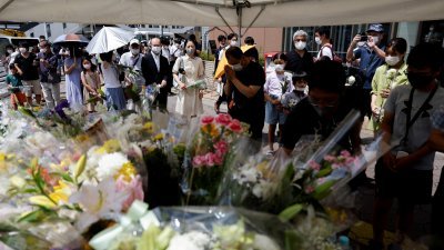 奈良大和西大寺站附近日本前首相安倍晋三被枪杀的地点，设置了献花台让人们献花哀悼。（图取自路透社）