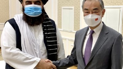 中国外长王毅（右）周四在乌兹别克首都塔什干出席上海合作组织外长会期间，会见塔利班任命的阿富汗代理外长穆塔基。（图取自中国外交部网站）