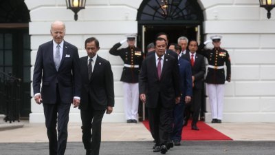 美国总统拜登周四在白宫主持东盟特别峰会时，与东盟领袖走向草坪拍摄合照。（图取自路透社）