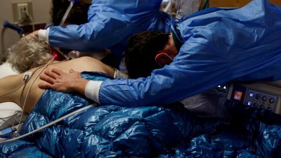 在美国加州的Providence Mission医院，新型冠状病毒患者在进行插管手术前，他的家属正拥抱安慰他。（路透社档案照）