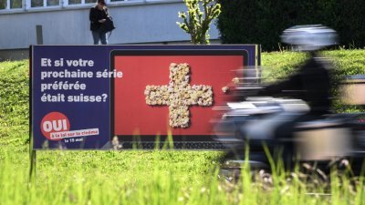 上周三，在瑞士西部城市伊韦尔东，街上一张大型海报呼吁民众对周日的《电影法》修订案投赞同票。（图取自法新社）