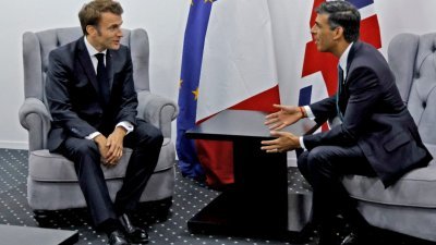 法国总统马克龙（左）与英国首相苏纳克于当地时间周一，出席在埃及举行的联合国气候变化大会之际举行场边会谈。（图取自法新社）