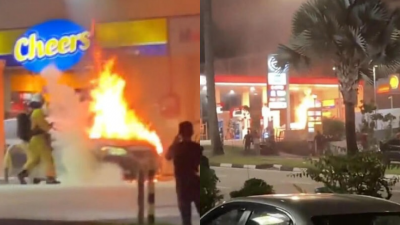 停在油站的轿车失火狂烧，民防部队随后赶到现场灭火。（受访者提供）