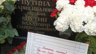 俄罗斯的反战人士，在普京父母位于圣彼得堡的坟墓前，留下一张斥责他们儿子的卡片。（图取自The Party of the Dead面子书）