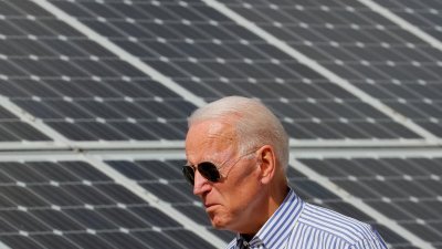 2019年6月4日，当时是民主党2020年美国总统候选人的拜登，在美国新罕布什尔州普利茅斯参观可再生能源计划时走过太阳能板。（图取自路透社档案照）