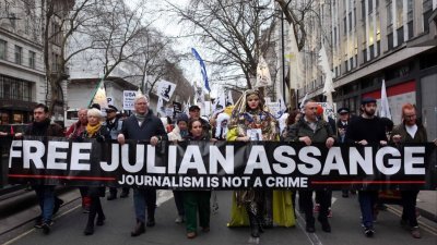维基解密创办人亚桑杰的支持者于2月12日在英国伦敦，举著“释放亚桑杰”的标语游行。（图取自法新社）