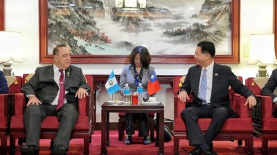 危地马拉总统贾马太（左）周一抵达桃园国际机场后，与台湾外交部长吴钊燮交谈。（图取自台湾外交部/法新社）