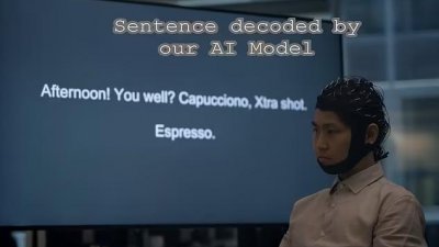 实验中，受试者带著人工智能头盔思考荧幕上显示的句子。（图取自网络）