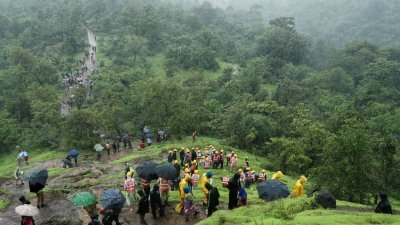 印度马哈拉施特拉邦莱加德伊沙尔瓦迪山村，周四（20日）发生山体滑坡事件，印度国家救灾部队（NDRF）人员及志愿者，当天爬上山前往现场展开搜救工作。（路透社档案照）