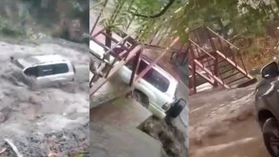 网传SUV车在打巴至金马仑路被洪水冲走视频，警方证实是假消息。（视频截图）