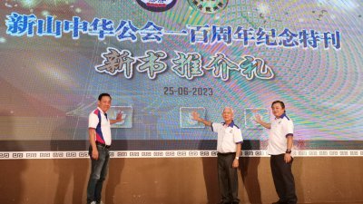 李富新（左起）、何朝东和林刚荣为新山中华公会百年纪念特刊主持推介。
