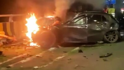 轿车失控撞及路旁栏杆后起火燃烧。