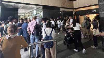 中国签证中心为应付人潮，从5月8日起不再接受现场排队领号申请紧急签证，当天有大批公众仍聚集中心外。 （档案照）