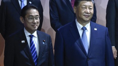 日本首相岸田文雄（左）和中国国家主席习近平，当地时间周四在美国三藩市，出席亚太经济合作论坛（APEC）领导人合影环节。（图取自法新社）