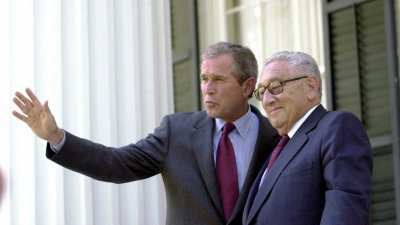 2000年7月12日在得州奥斯汀州长官邸的门廊上，得州州长兼共和党总统候选人布什（左）站在基辛格旁边，向记者挥手致意。（图取自法新社档案照）