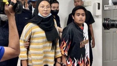 努鲁雅欣金（左）及刘艾雯（译音）戴著手铐被押往法庭接受审判，法官因病告假，案件展延至11月1日下判。