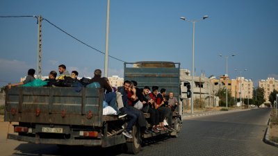在以色列命令加沙北部超过100万平民向南迁移后，巴勒斯坦人坐上卡车逃离家园。（图取自路透社）