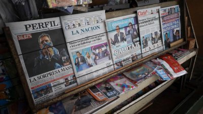 阿根廷首都布宜诺斯艾利斯一家报亭，周一贩卖的报纸展示了阿根廷周日举行的第一轮投票结果。（图取自路透社）