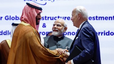 会议结束时，拜登（右）走向G20峰会东道主印度总理莫迪，与他和沙地王储穆罕默德共同握手。（图取自路透社）