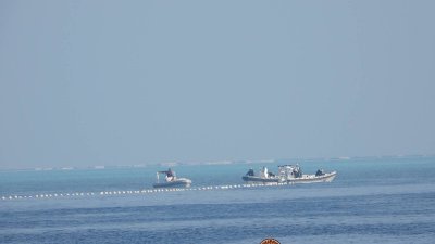 菲方指控北京在黄岩岛局部设置漂浮障碍物，阻挡菲国渔民进入捕鱼。图为中国海警船上周三靠近该漂浮障碍物。（图取自菲律宾海岸警卫队/路透社）