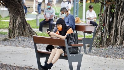 台湾在4月17日起松绑口罩令，但有民众外出时脸上不忘戴好口罩。图为5月9日午后，民众在高雄市凤山区一处公园休憩。（图取自中央社）
