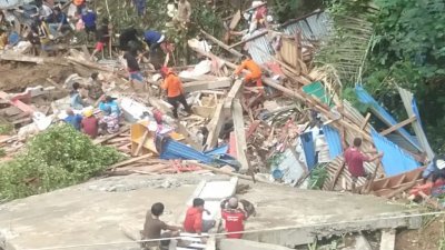 印尼南苏拉威西省塔纳托拉雅县周六晚发生山体滑坡后，救援人员和居民在被埋的房子展开搜救。 （图取自印尼国家灾害应变总署网站）