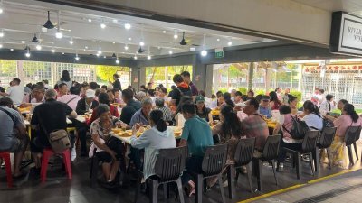 新加坡吉兰丹路组屋楼下的咖啡店最近开始接待旅行团，碰上尖峰时段座无虚席。