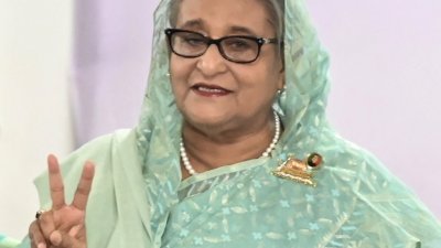 孟加拉执政党在周日大选中赢得国会过半席位，寻求连任的哈西娜几乎肯定能第5度出任总理。（图取自路透社）