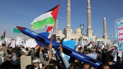 周五在也门首都萨那，支持“青年运动”的民众手持火箭模型参加集会，反对美国对“青年运动”目标的袭击以及以色列对加沙的持续袭击。（图取自路透社）