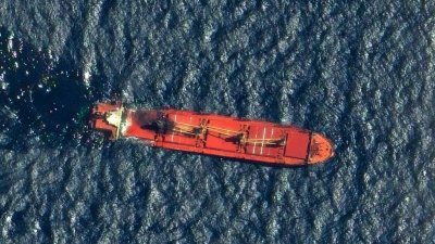 Maxar Technologies周六发布日期为3月1日的卫星图像显示，英国货船“红宝石”号被攻击损坏后在红海漂浮，燃油从船上泄漏出来。（图取自Maxar Technologies/法新社）