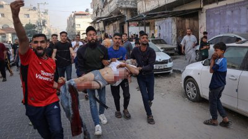 以军在周日空袭拉法作为哈马斯发射火箭弹导致3名士兵死亡的回应。图为一群巴勒斯坦男子从被摧毁的房屋废墟中，救出一名受伤老年人。（图取自法新社）