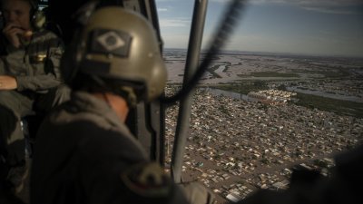 巴西军事人员当地时间周三乘坐直升机，在南里奥格兰德州阿雷格里港上空，观察被洪水淹没的地区。（图取自法新社）