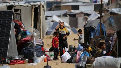 在加沙地带南部城市拉法避难的巴勒斯坦人，周三又开始收拾家当，准备逃往拉法更安全的地方，躲避以色列的轰炸。（图取自法新社）