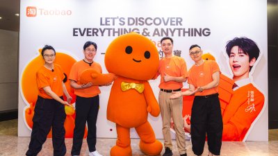 “跨国用户六大焕新体验”介绍会上，何玫（左起）、叶剑秋、丁宏伟以及董祺与淘宝公仔合影。

